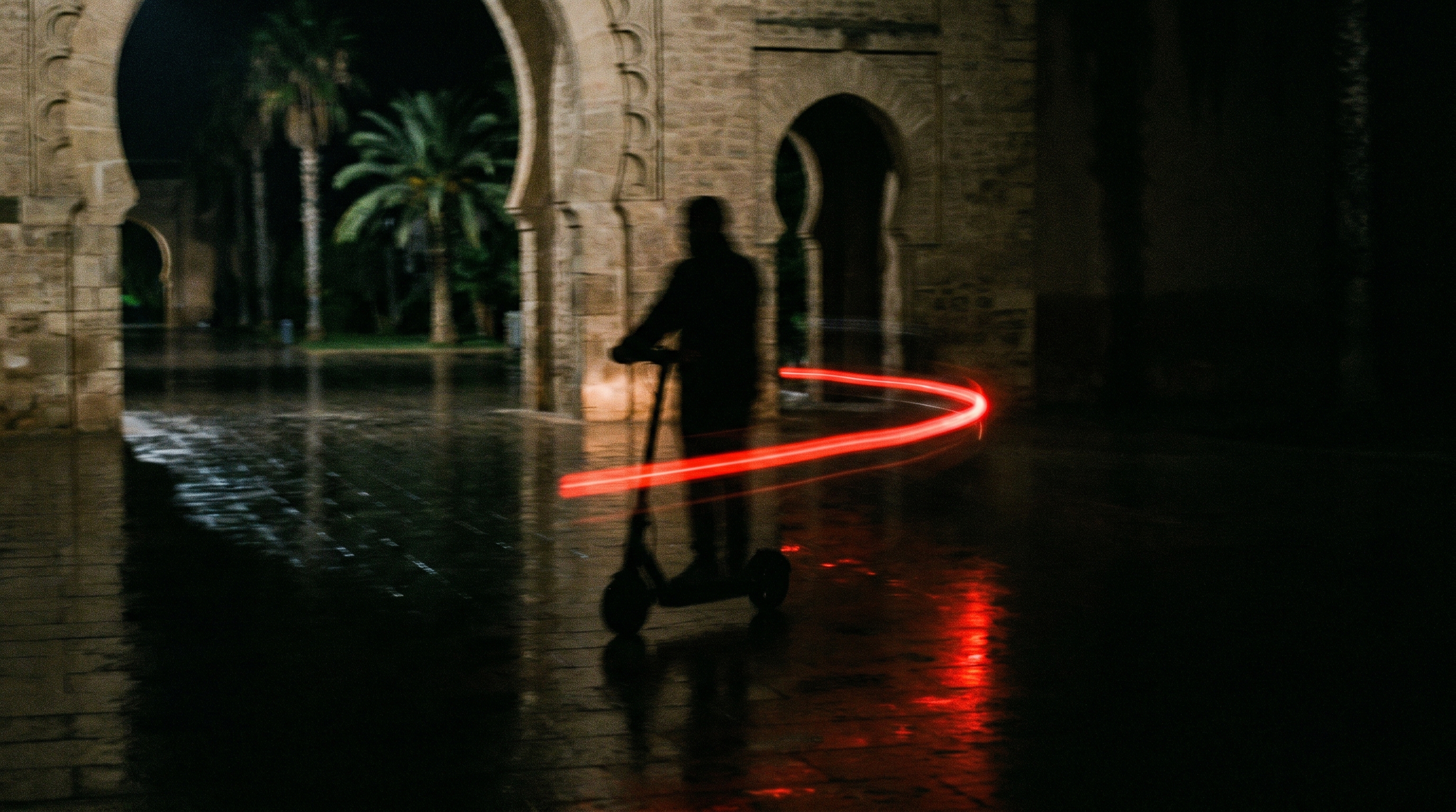 Student riding an Elyra scooter across campus